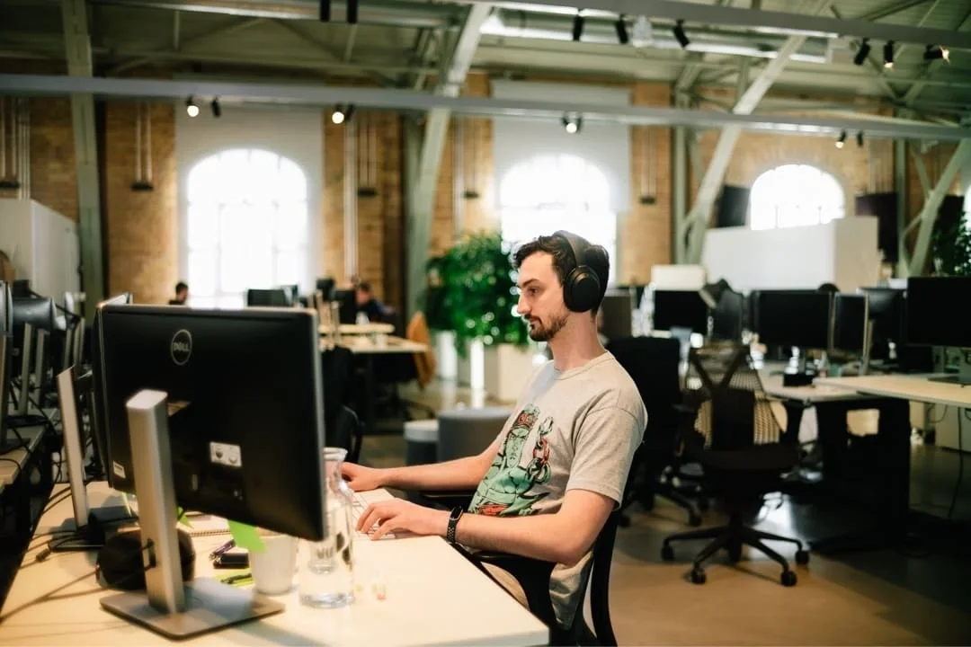 Picture - Man at at desk with lots of screens