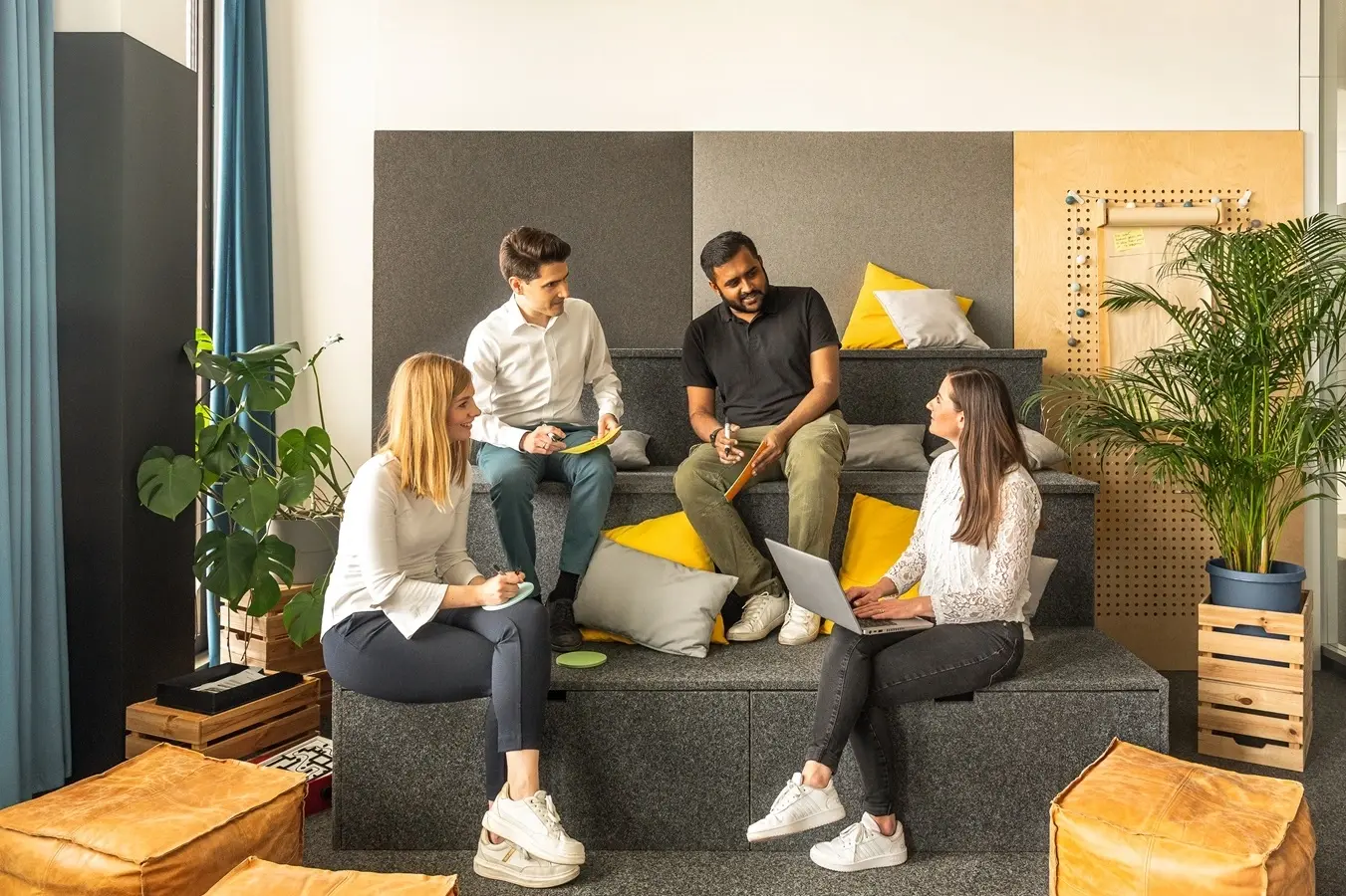 Picture - Four people sitting on stairs and discussing